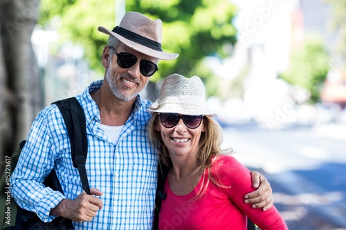 Smiling mature couple standing on sidewalk