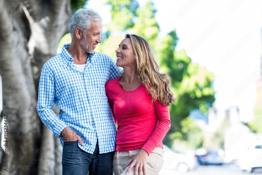 Fototapeta premium Romantic mature couple standing against tree