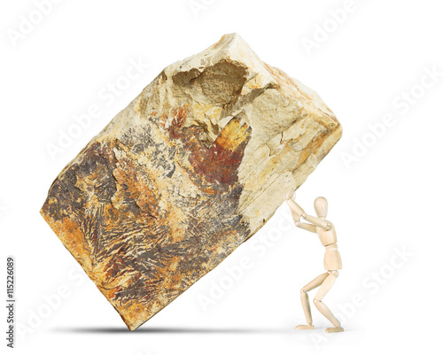 Man lifts up a huge rock. Abstract image with a wooden puppet