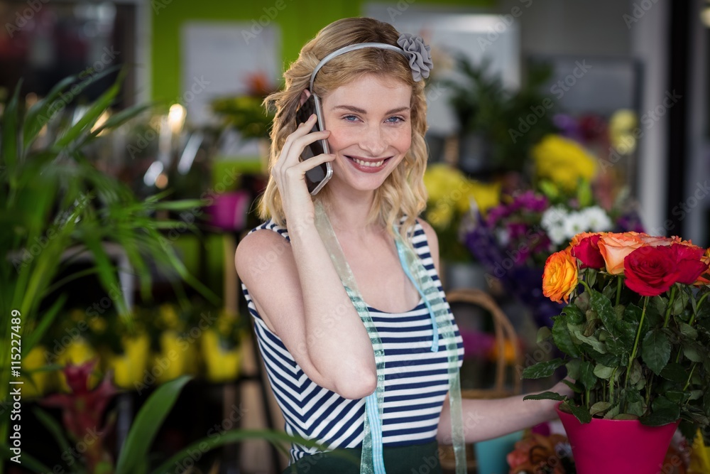 Female florist talking on mobile phone Female florist talking on mobile phone