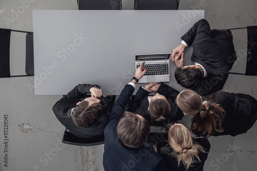 Business people look at laptop