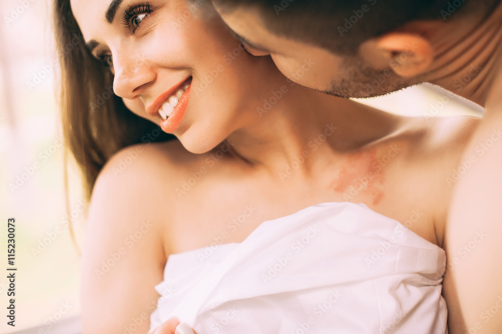 couple in love wrapped in a towel, hugging on the balcony couple in love wrapped in a towel, hugging on the balcony