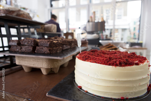 Red velvet cake and chocolate brownies on cafe counter photo