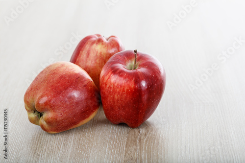 apples on a wooden surface