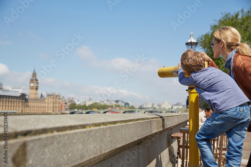 Mother and son using coin operated binoculars