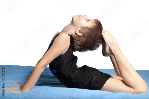 The boy does gymnastics
