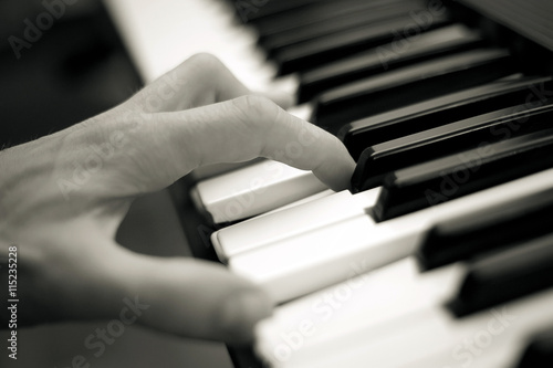 Close-up of hand playing the piano
