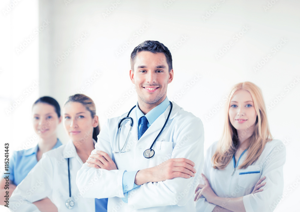 male doctor in front of medical group male doctor in front of medical group