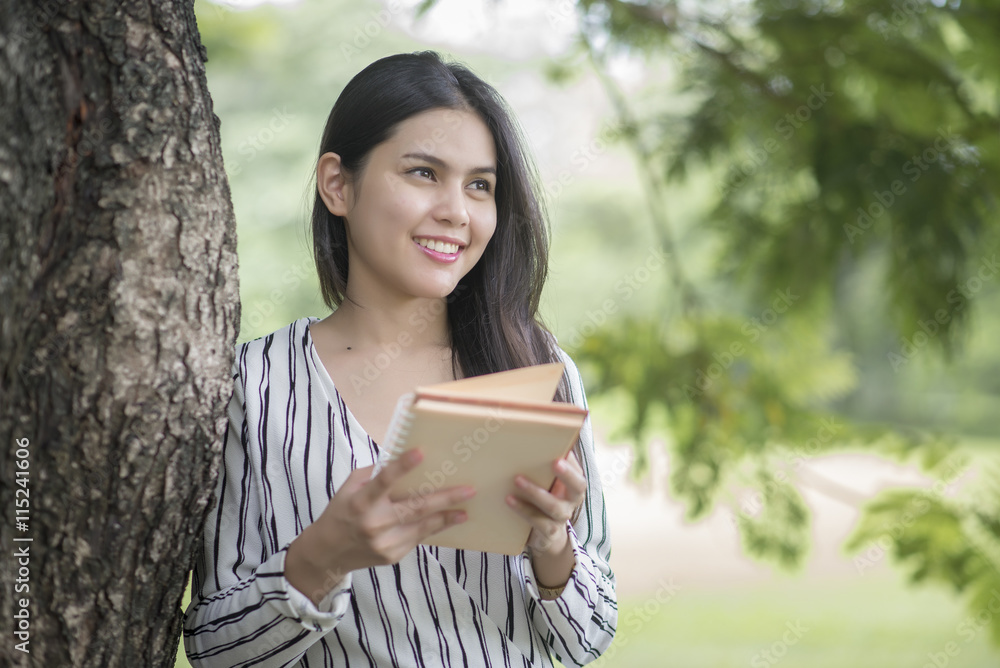Attractive woman reading a book in the park Attractive woman reading a book in the park