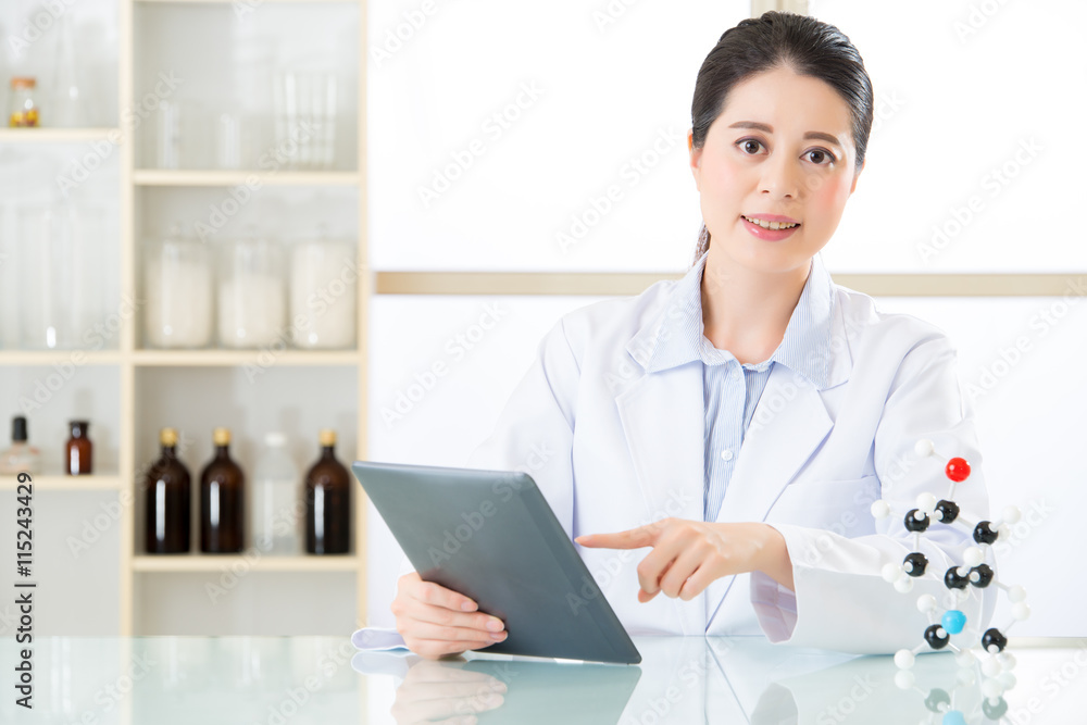 asian female chemist use notepad to research for future Chemical asian female chemist use notepad to research for future Chemical