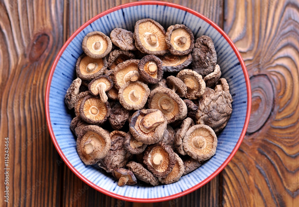 Dried shiitake mushrooms on a wooden background. Dried shiitake mushrooms on a wooden background.