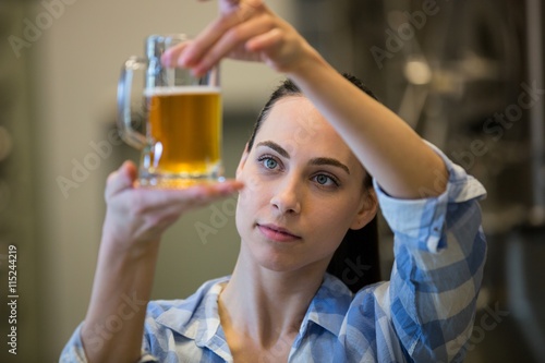 Fotografie Close-up of female brewer testing beer