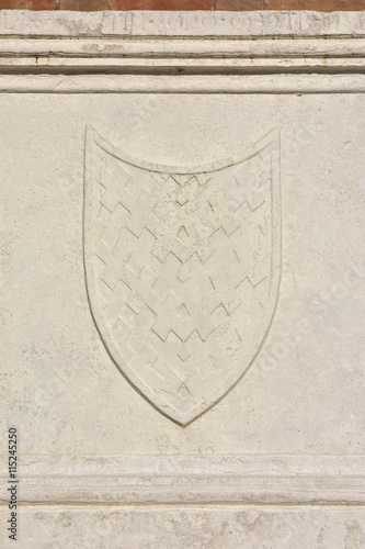 Relief of a shield from an ancient sarcophagus on St John and Paul gothic facade, in Venice