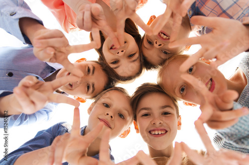 happy children showing peace hand sign