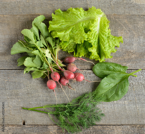 Organic food. ingredients for saladon old, rustic, wooden table. photo