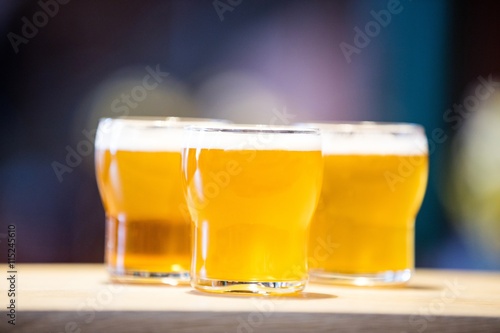 Three beer glasses on the bar counter photo