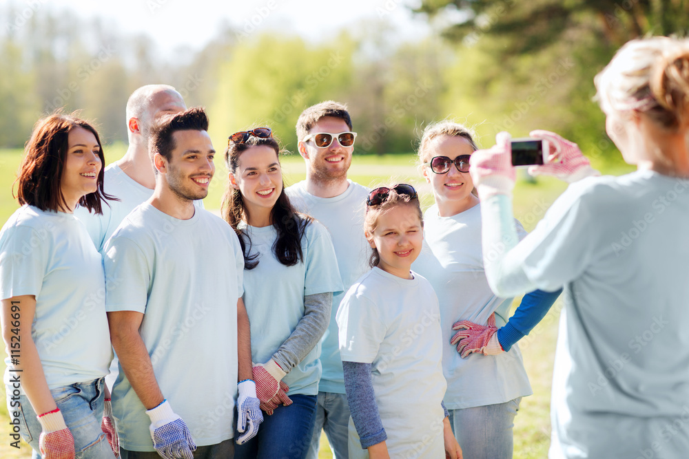 group of volunteers taking picture by smartphone group of volunteers taking picture by smartphone