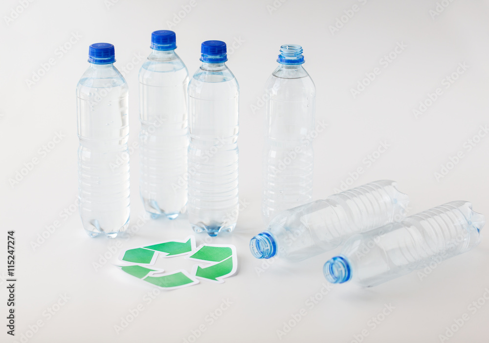close up of plastic bottles and recycling symbol close up of plastic bottles and recycling symbol