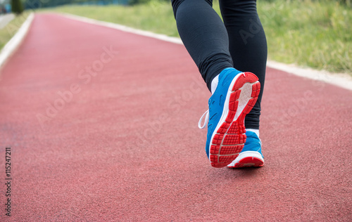 Close up portrait of female runner legs at stadium