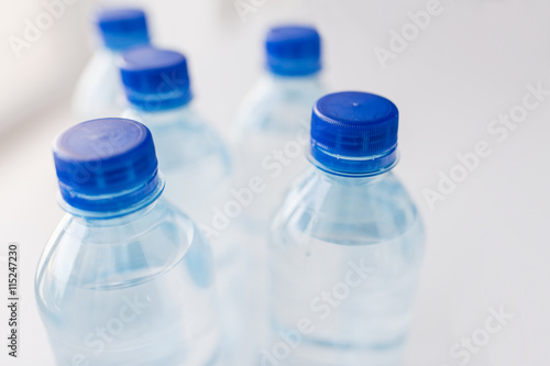 close up of bottles with drinking water on table