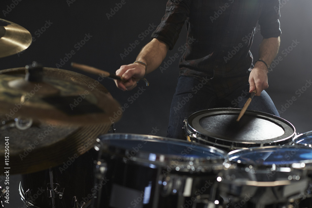 Naklejka premium Close Up Of Drummer Playing Drum Kit In Studio