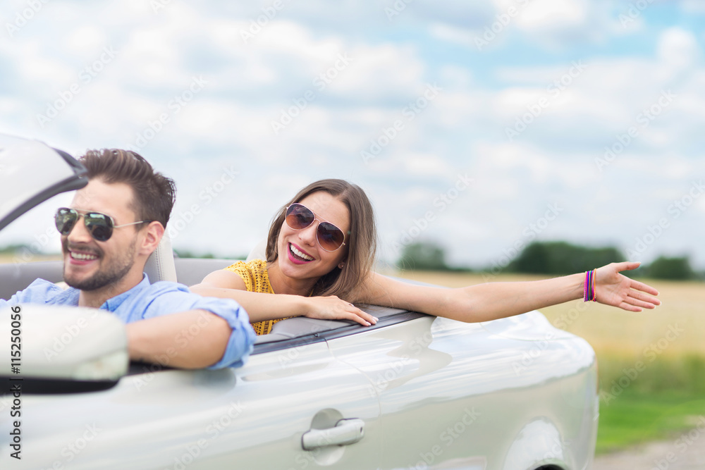 Happy Couple Driving in Convertible
