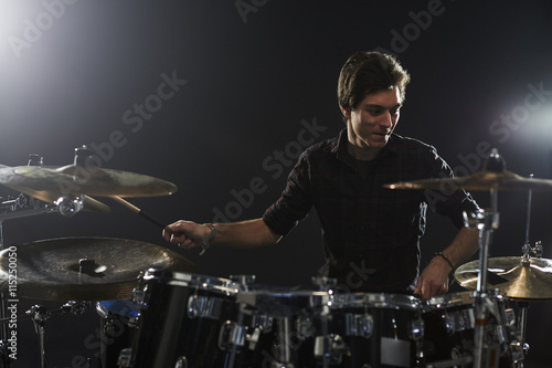 Young Drummer Playing Drum Kit In Studio
