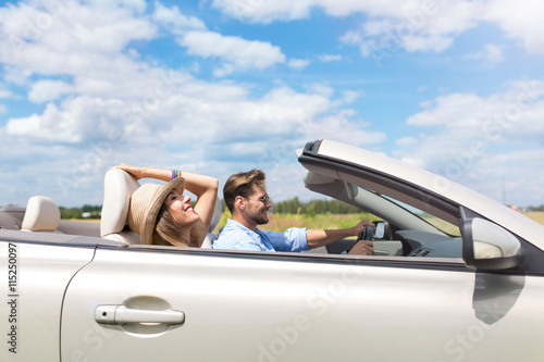 Happy Couple Driving in Convertible   © pikselstock