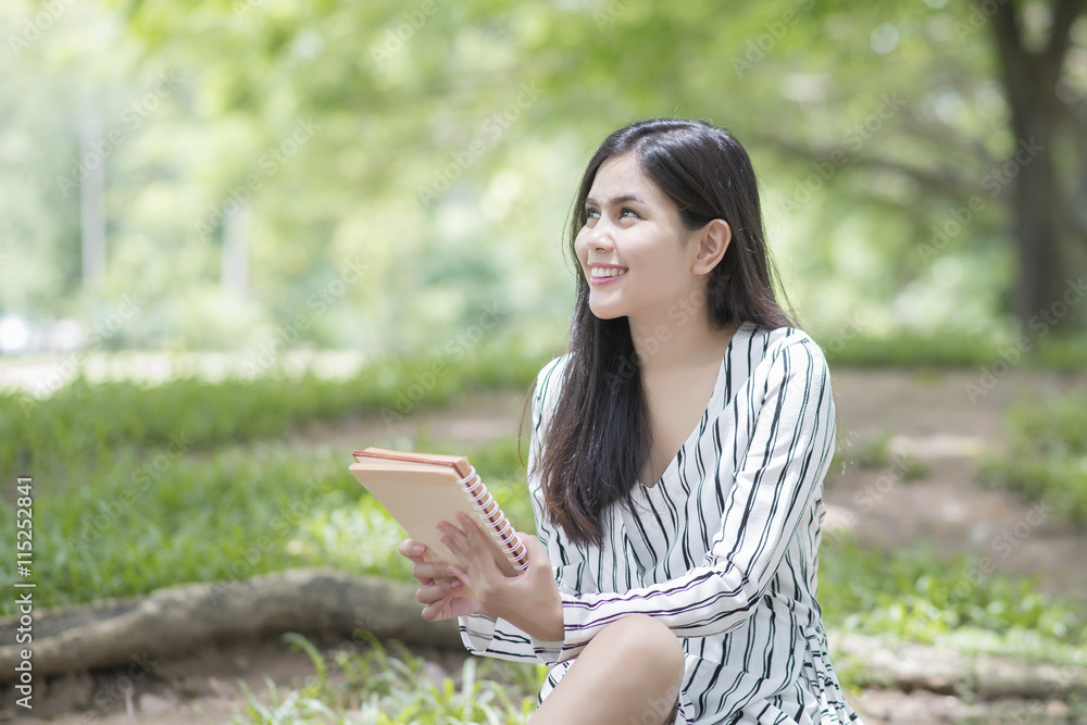 Attractive woman reading a book in the park Attractive woman reading a book in the park