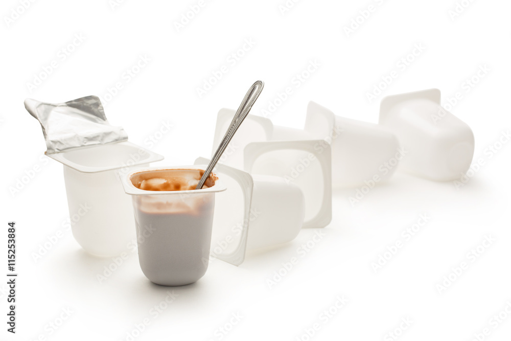 Open yogurt in pot with metal spoon Open yogurt in pot with metal spoon