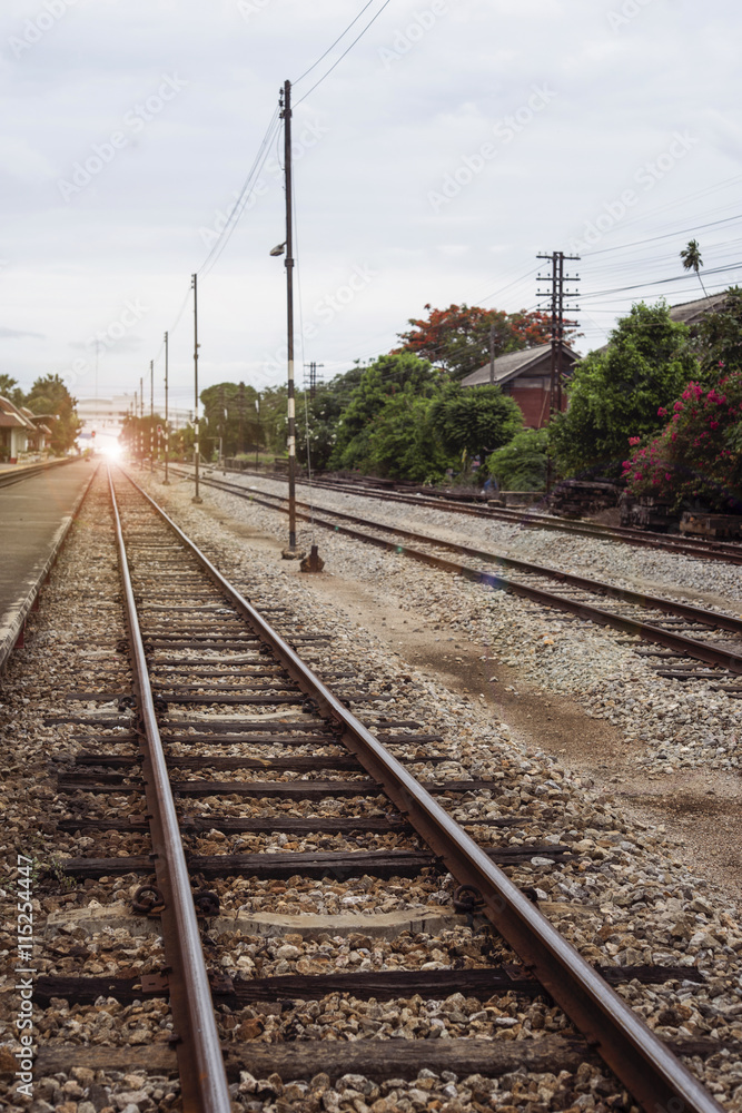 view of the length of railway ,Perspective railway,filtered image, light effect and flare added,selective focus