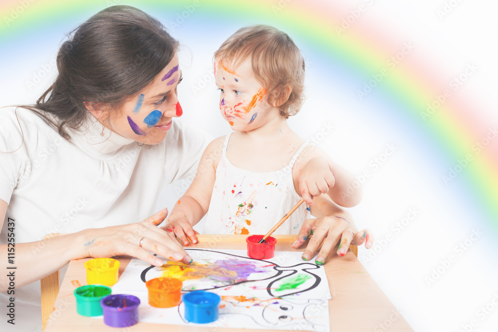 Mom and baby draws with colored inks paint