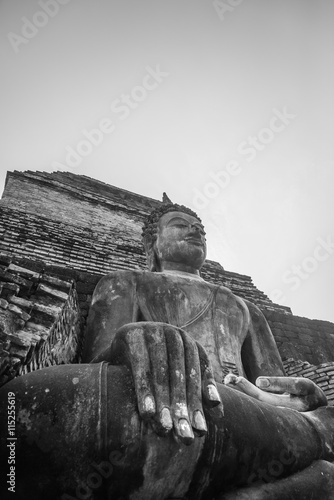 Black and white view of old buddha statue in ancient temple