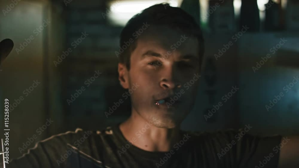 Portrait of an auto mechanic with a cigarette in his mouth in car service Portrait of an auto mechanic with a cigarette in his mouth in car service