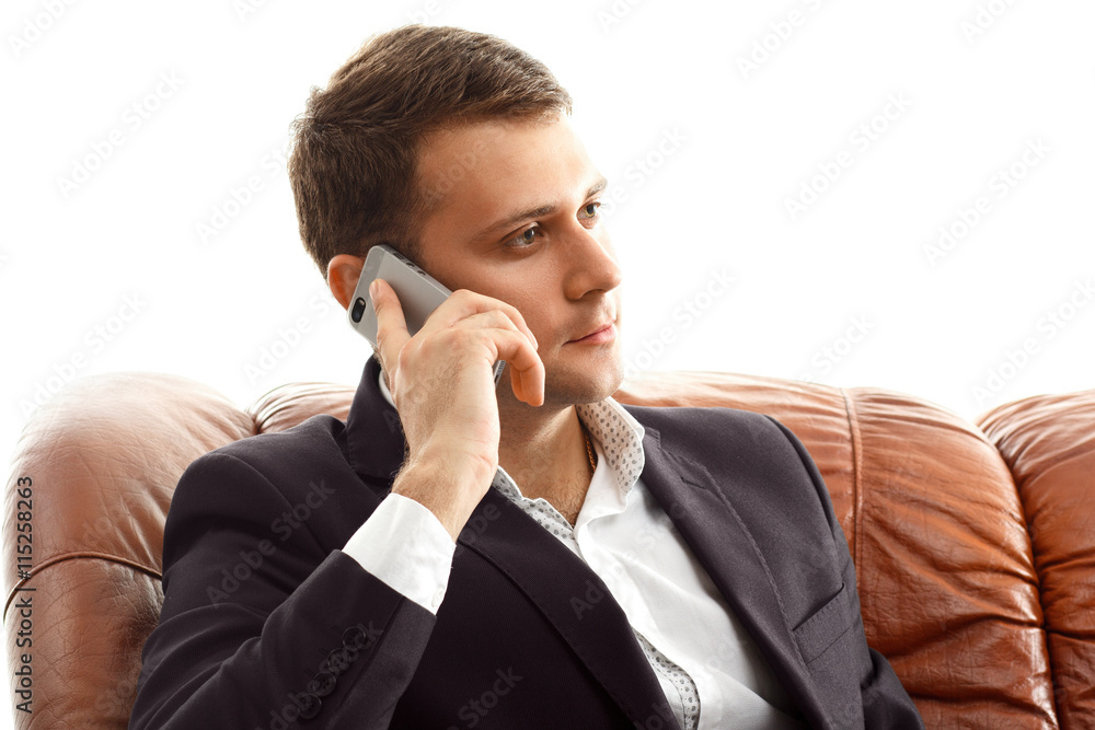 Businessman talking phone .sitting on the couch Businessman talking phone .sitting on the couch