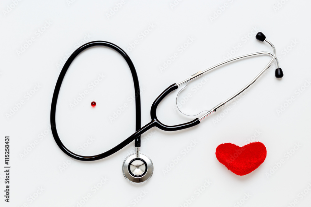 stethoscope on white background with plush heart top view stethoscope on white background with plush heart top view