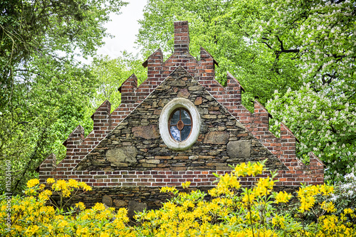 Woerlitzer Park, gothic roof behind yellow bush photo