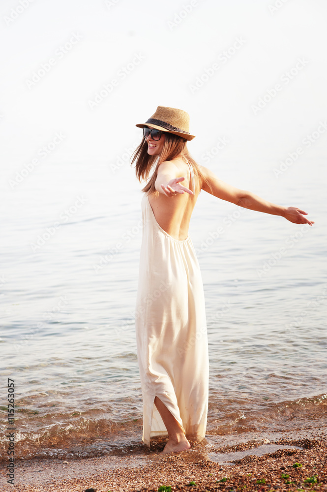 Young smiling woman enjoy summer holidays on a sea beach Young smiling woman enjoy summer holidays on a sea beach