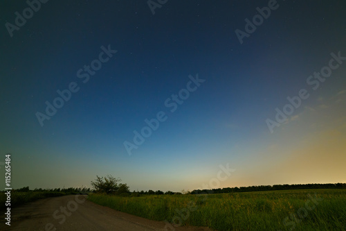 Country road on a background of the starry night sky.
