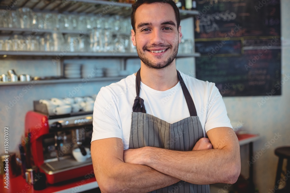 Portrait of confident waiter with arms crossed at cafe Portrait of confident waiter with arms crossed at cafe