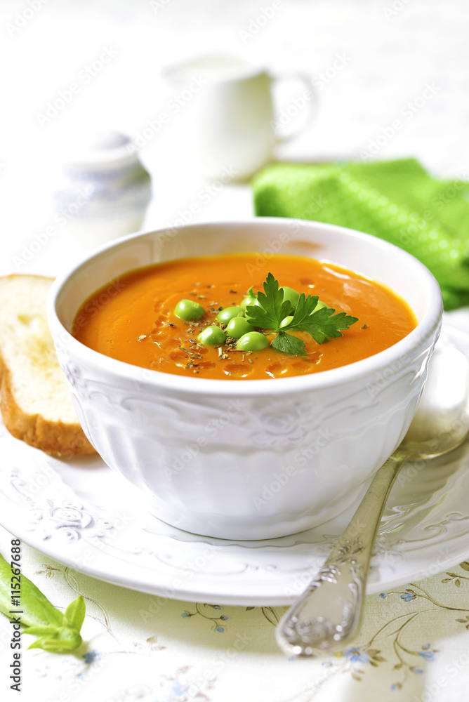 Carrot creamy soup with green pea.