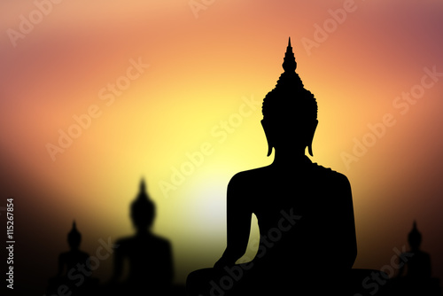 Silhouette of Buddha with sun shining from behind. © buraratn