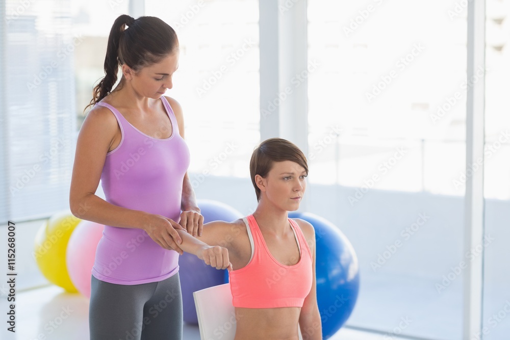 Trainer guiding woman