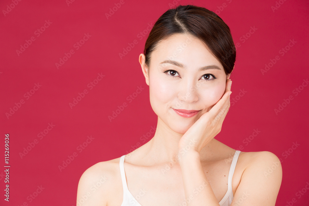 attractive asian woman isolated on red background attractive asian woman isolated on red background