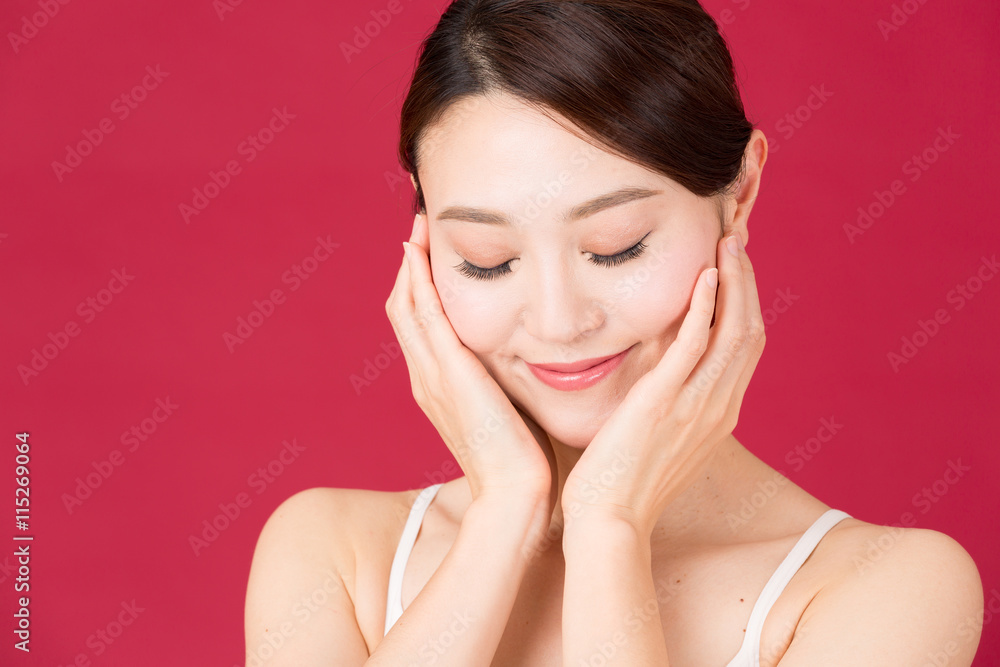 attractive asian woman isolated on red background