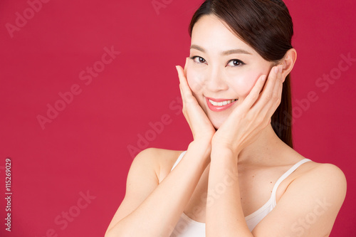 attractive asian woman isolated on red background