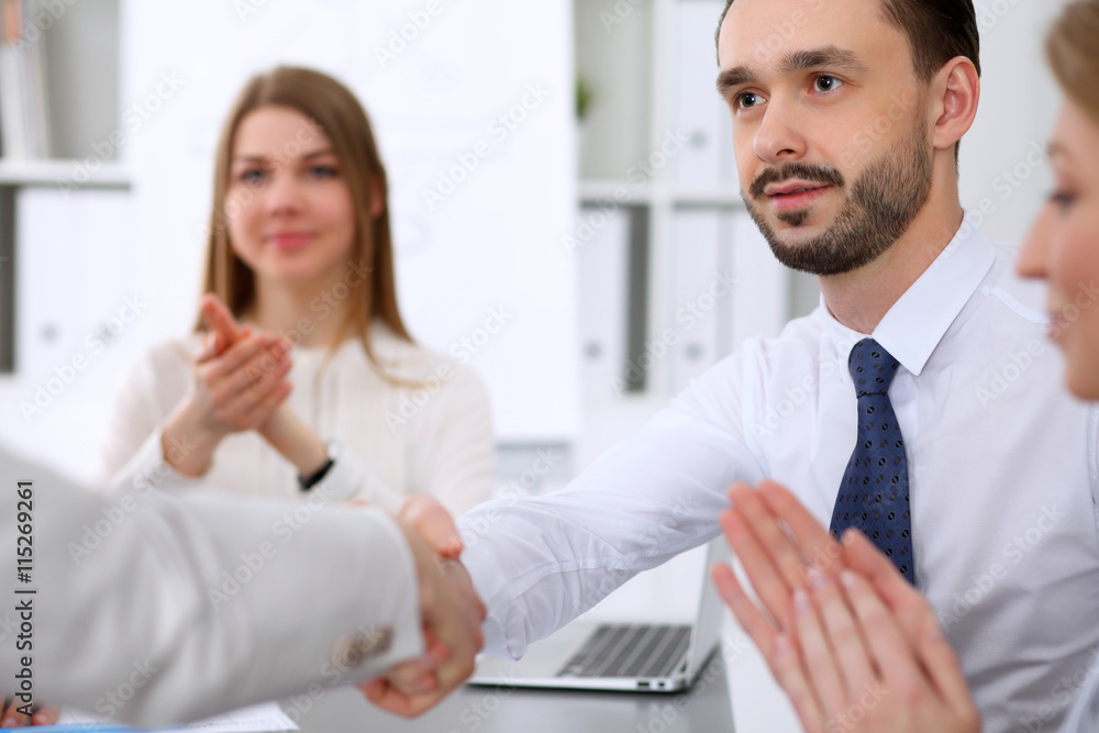 Two business man shaking hands to each other finishing up the meeting Two business man shaking hands to each other finishing up the meeting