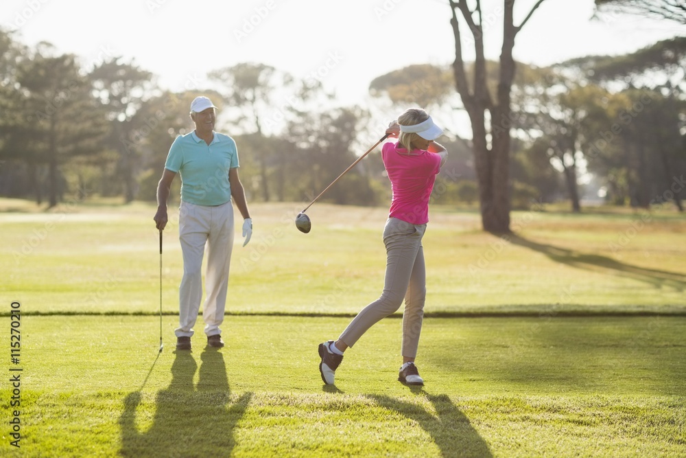 Fototapeta premium Mature golfer playing by man