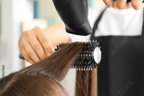 Professional hairdresser drying hair