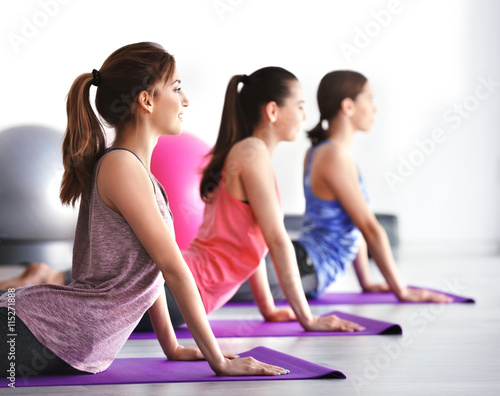 Young women doing yoga in gym
